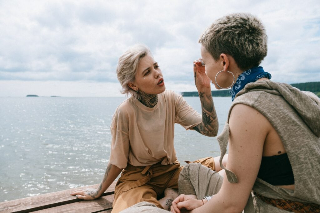 Lesbian couple talking on the beach
