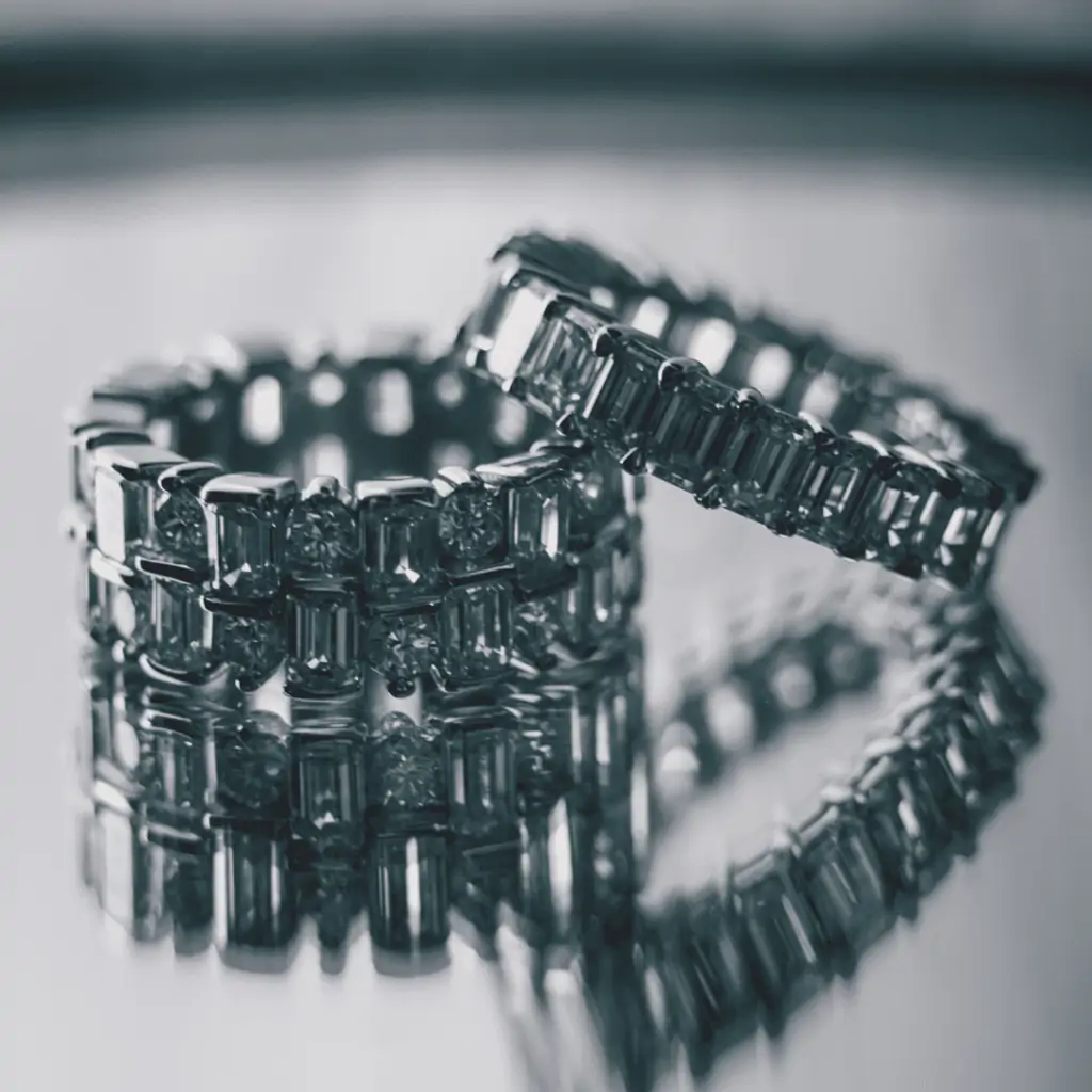  A close up view of two diamond wedding bands on a mirror surface
