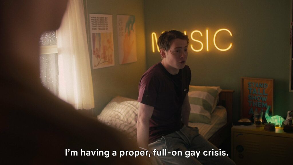 Bisexual character Nick Nelson from the Netflix series Heartstopper experiences bi panic in this scene. He sits on Charlie Spring’s bed, soaked in rain, clearly in distress as he exclaims  “I’m having a proper, full-on gay crisis.”