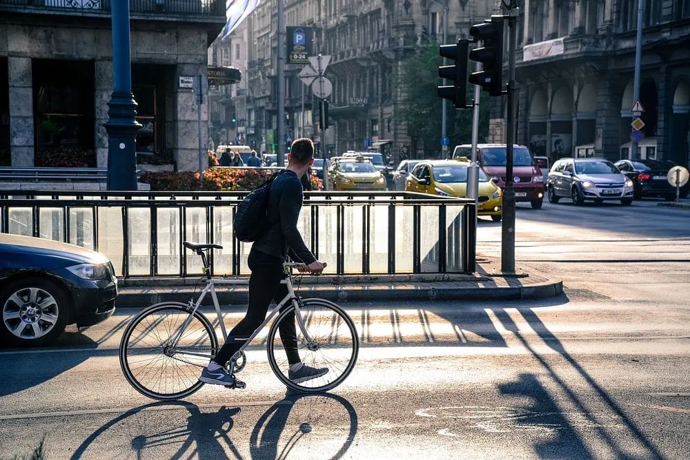 A biker watches oncoming traffic in New York City