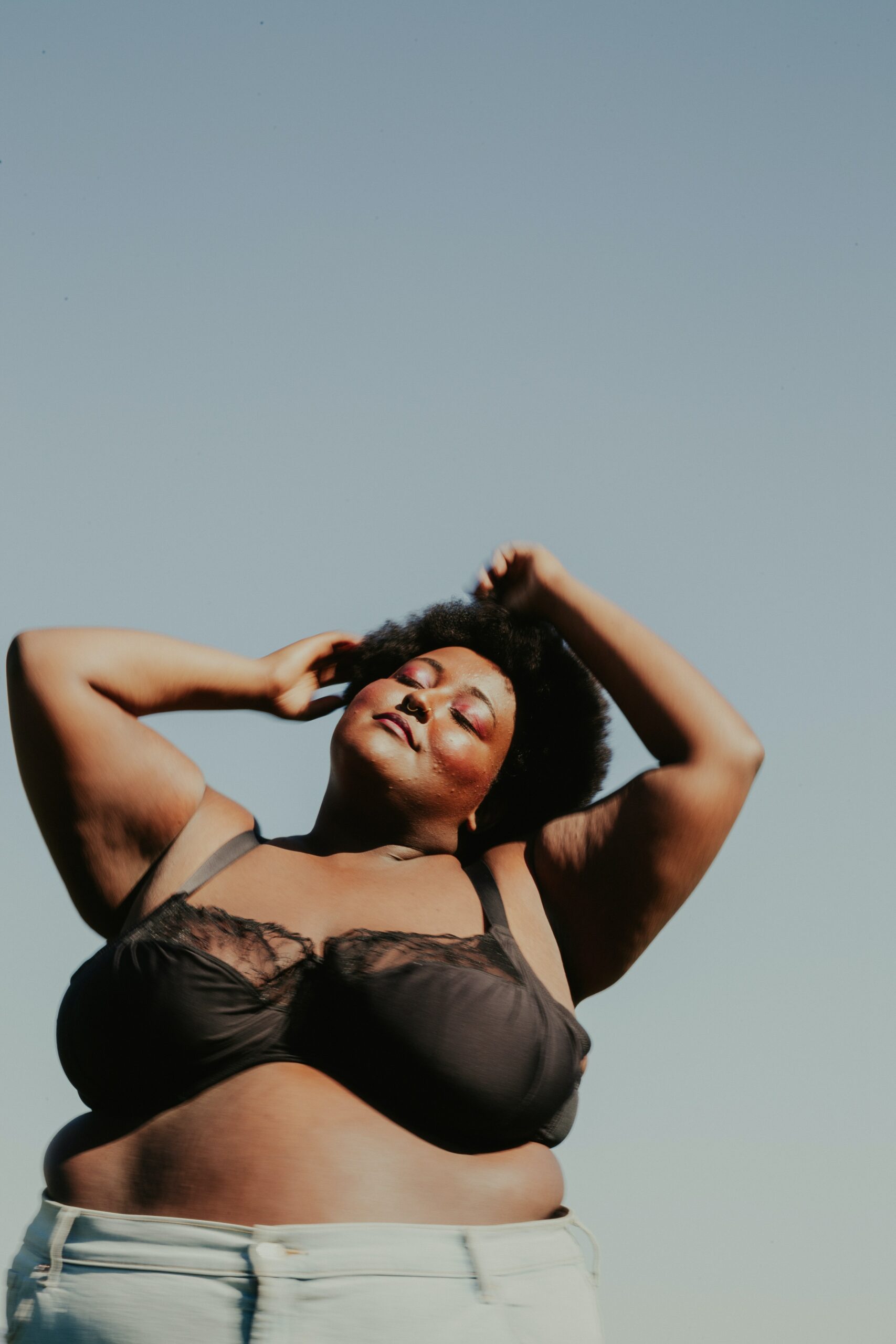 Woman in bra feeling herself