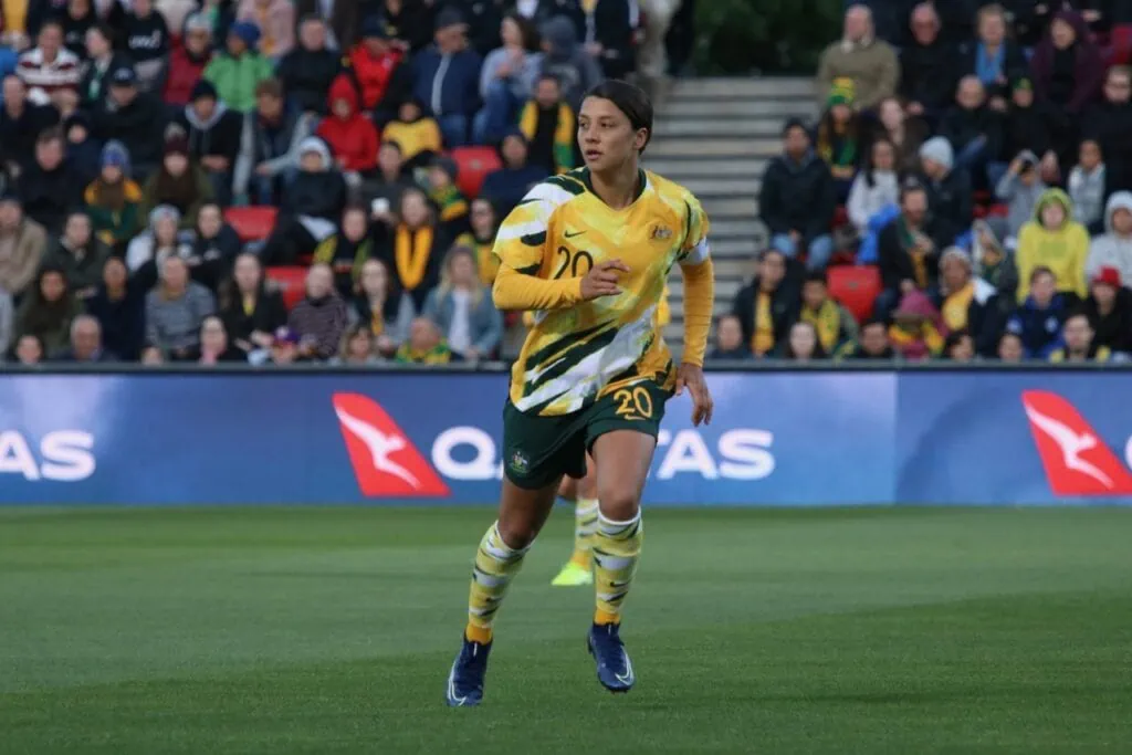Sam Kerr on the field, mid-run, in the middle of a game.