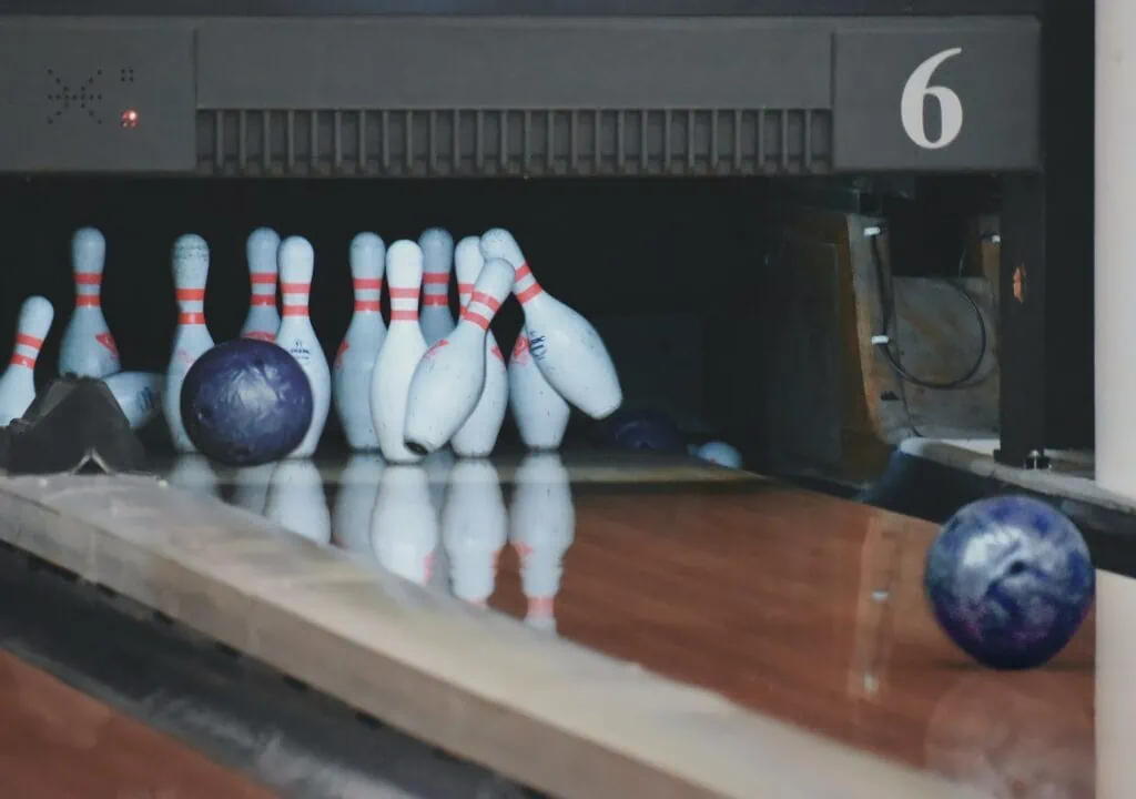 A bowling bowl knocking in a set of bowling pins. Bowling can be a great activity-based first date for someone who is introverted.