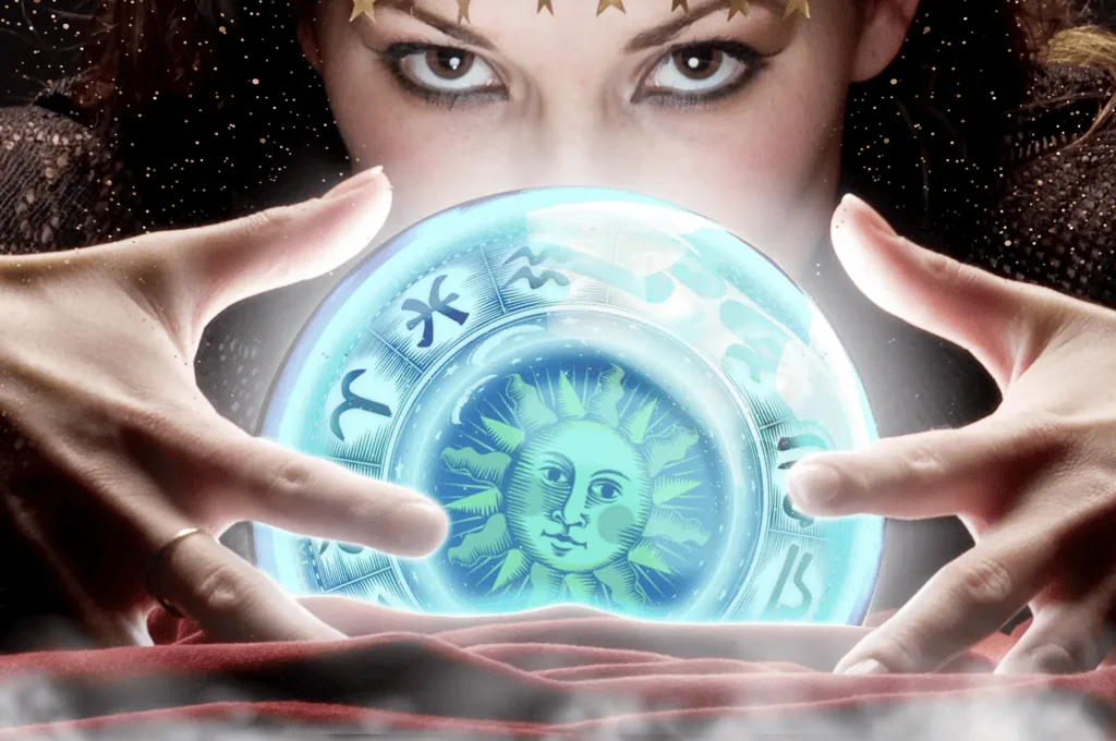  Woman looking into a crystal ball, reflecting the zodiac signs