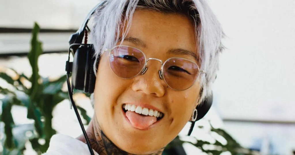 Queer polyamorous person making a polyamorous playlist of songs for polyamorous relationships 