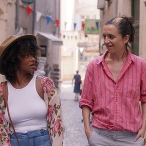 A scene from ‘Ma Belle, My Beauty,’ a queer polyamorous movie set in the South of France. The two women who star in the movie walk in the streets, making eye contact. 