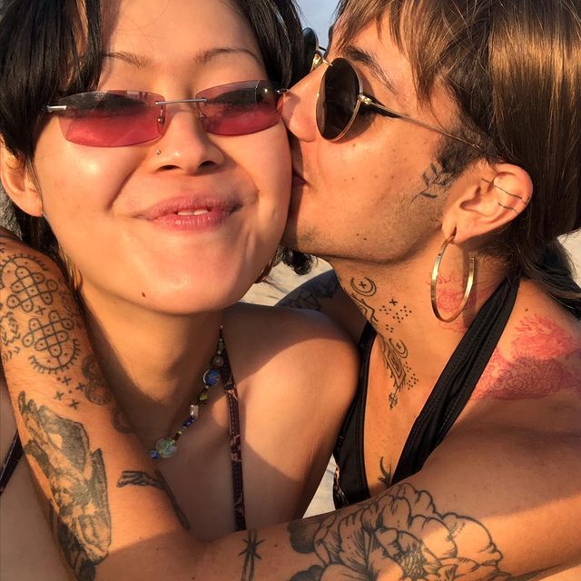 Trans couple kisses at sunset 