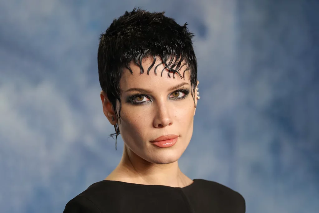 Halsey at the 2023 Vanity Fair Oscar Party, with a short pixie cut and smokey makeup.