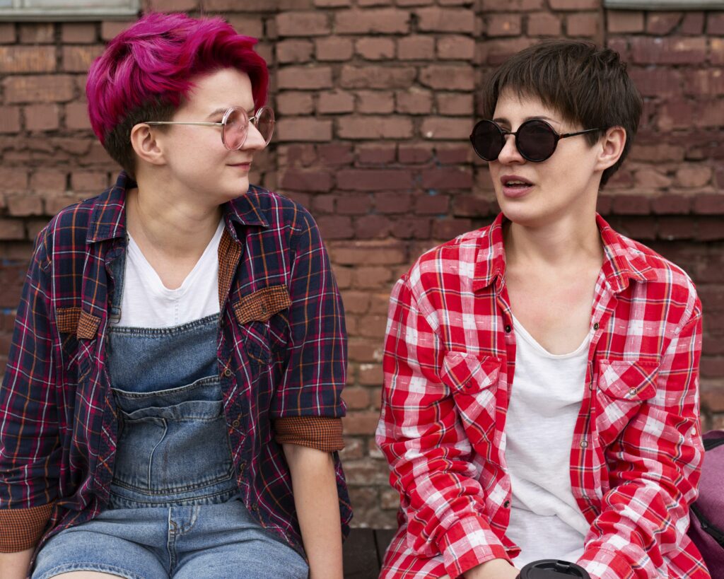 Two people sitting together outside.