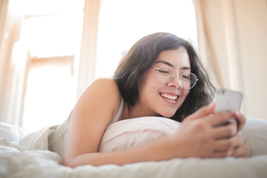 Woman on her phone in bed