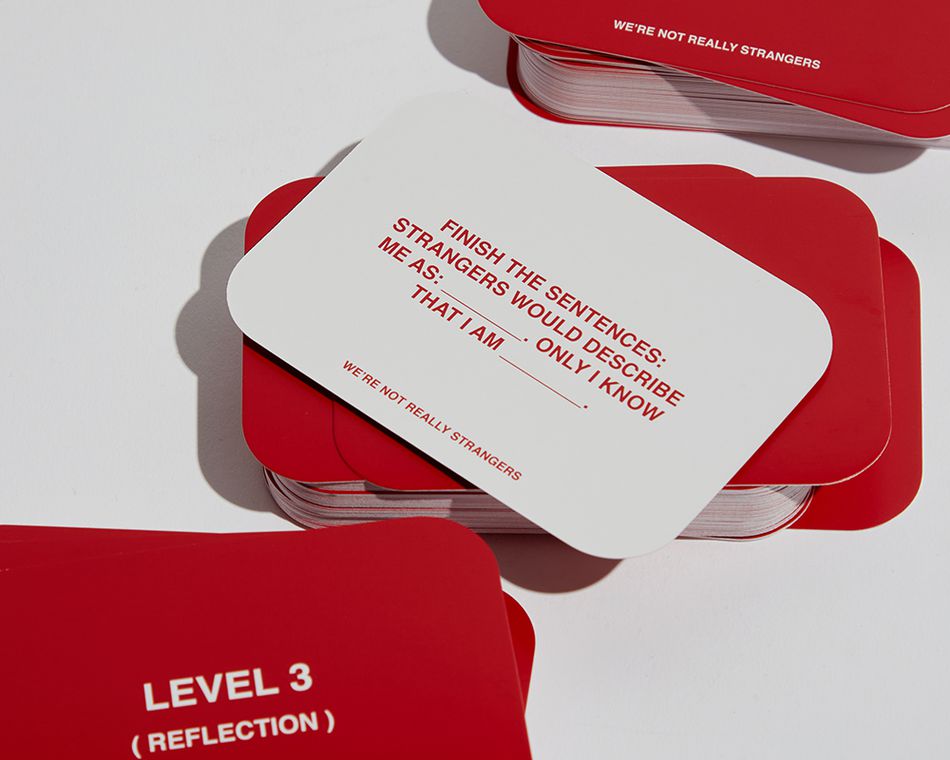 We’re Not Really Strangers is a fill-in-the-blank style conversation card game, characterized by its red-and-white branding and deep questions. Perfect for a queer date night.
