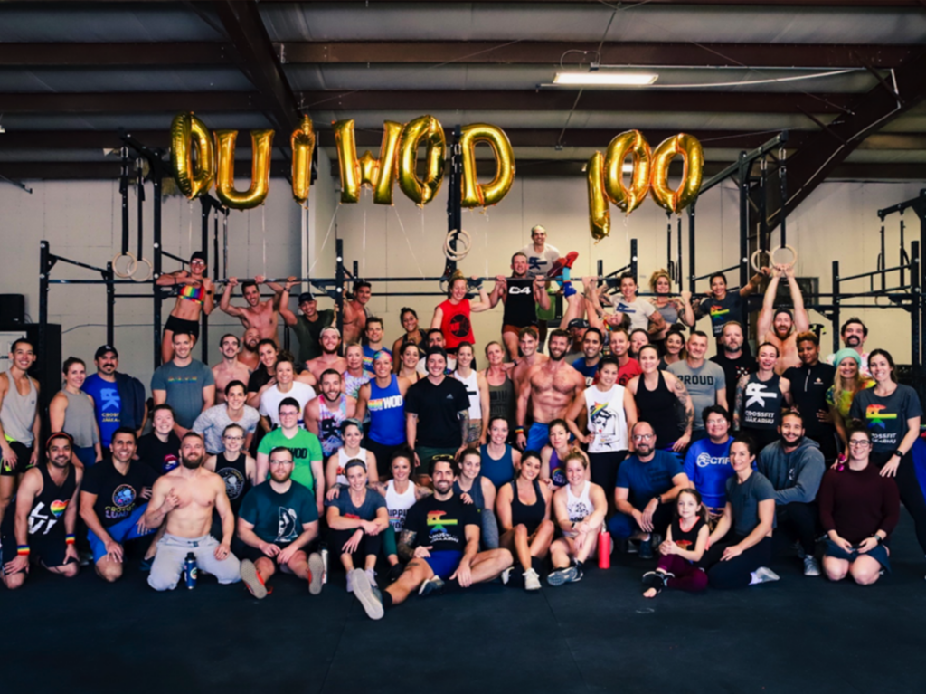 group photo of diverse individuals smiling and posing together at an OUTAthletics event hosted by The OUT Foundation, showcasing pride and camaraderie.