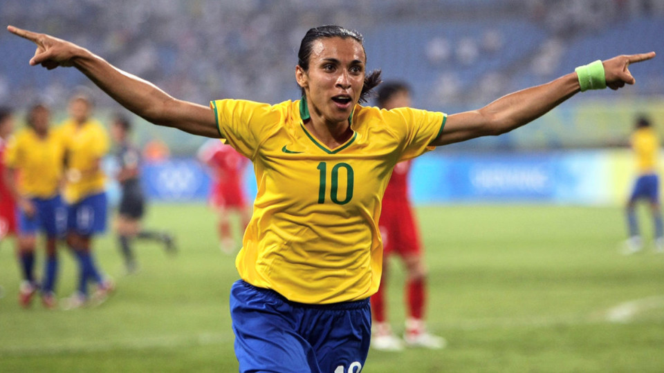 Marta Vieira da Silva, one of the best lesbian soccer players in the world, runs across the field with the arms outstretched in her iconic yellow Brazilian #10 jersey.