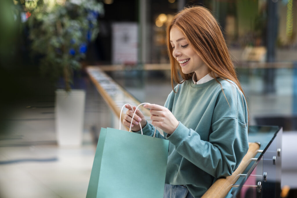 Woman looking inside shopping bag.