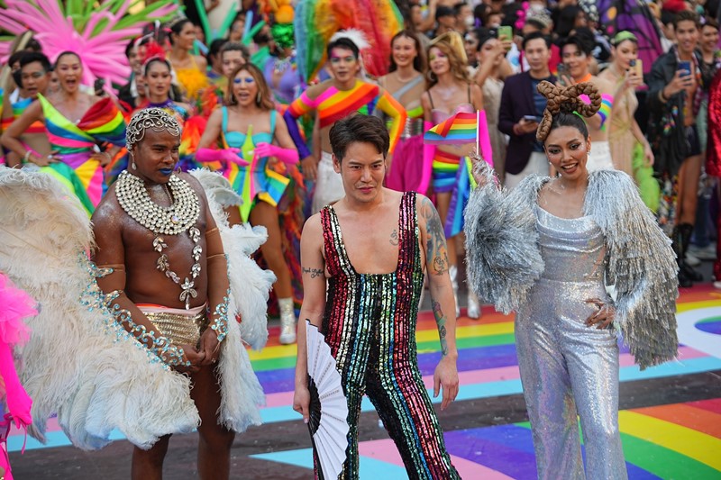 A group of celebrities, singers, and actors walk down the Rainbow Runway for Equality at Central World, promoting inclusivity and diversity.
