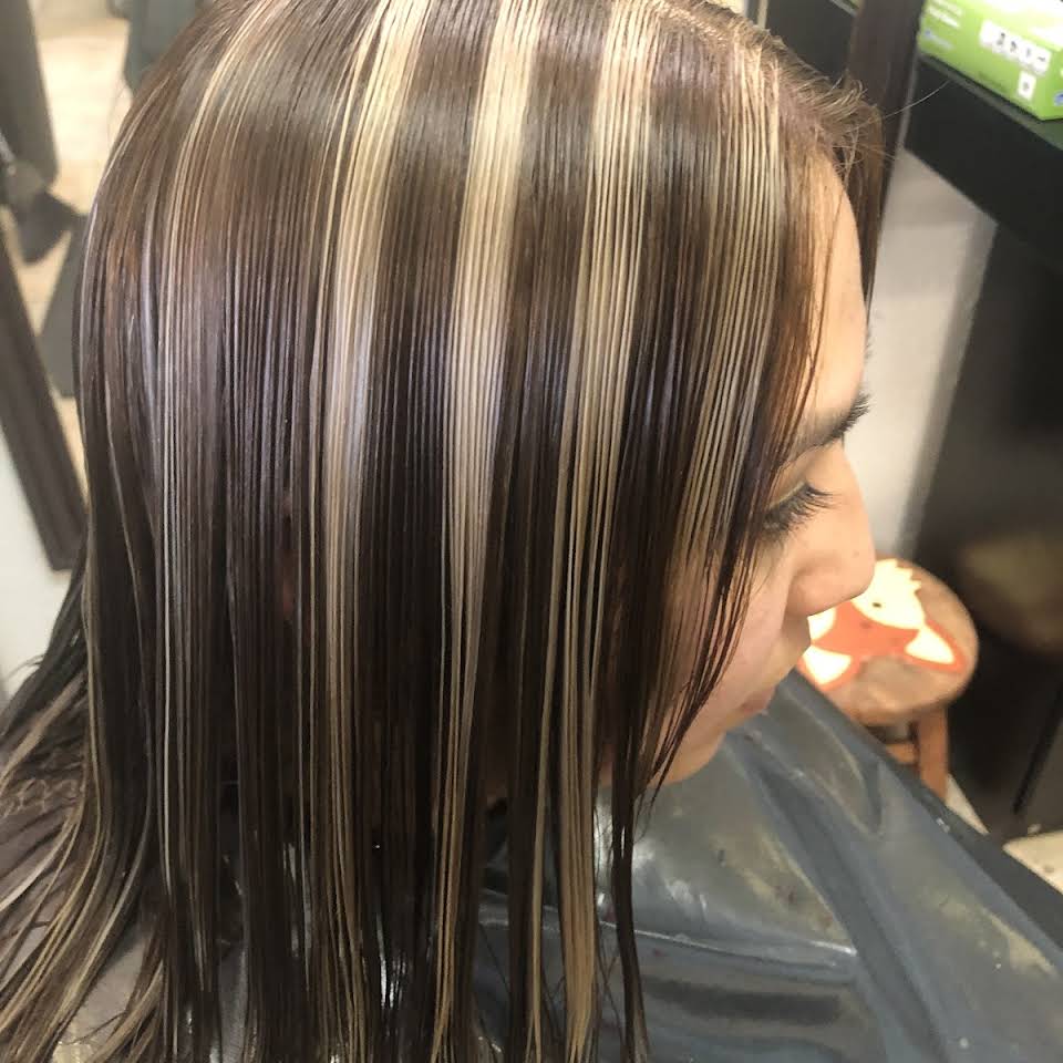 Lesbian client getting a stylish haircut at Vanity Hair Studio, one of the top LGBTQIA+ inclusive salons in Las Vegas