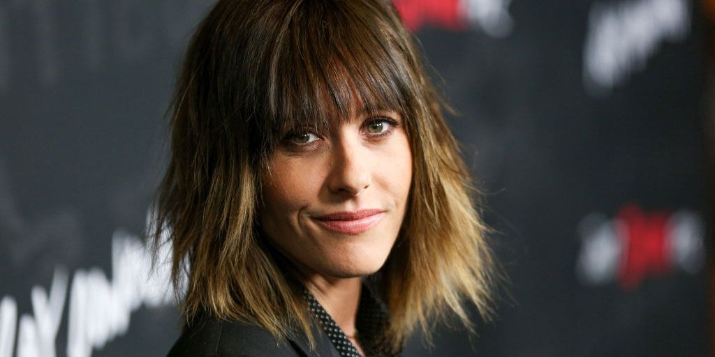 Photo of Katherine Moennig wearing a black suit.