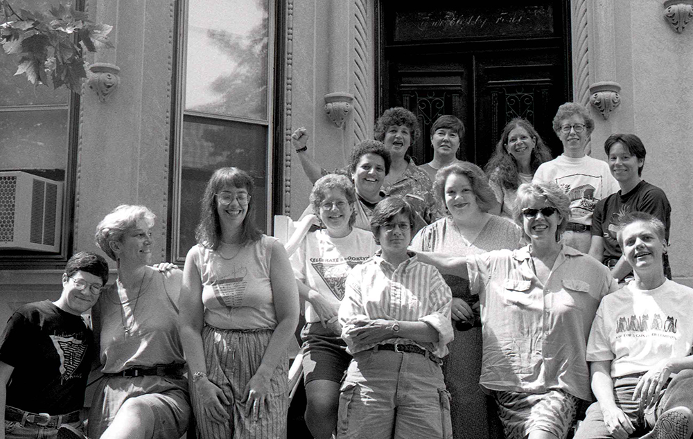 Group photo of coordinators in 1993, standing proudly in front of the new Lesbian Herstory Archives building.