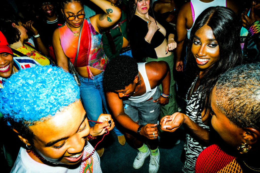 Inside the Bush bar, queer people dance joyfully.