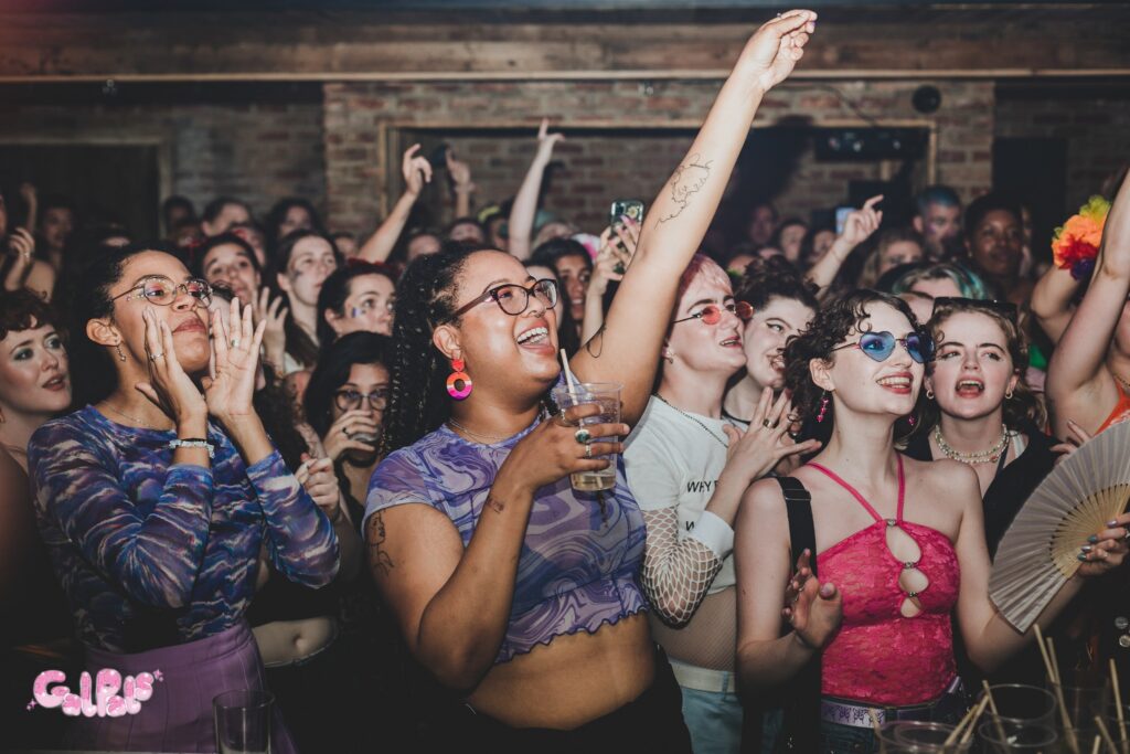"GAL PALS: London Pride," one of the London Pride 2024 events, full of lesbians and sapphics from the LGBT and queer communities dancing and waving