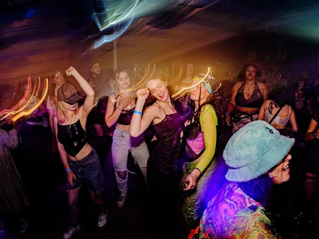 A group of lesbians are having a fantastic time dancing at a club in LA during Pride Month 2024.