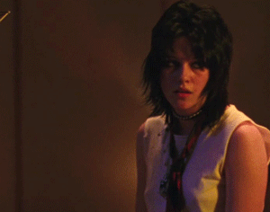 Kristen Stewart portraying Joan Jett in The Runaways, exuding confidence and charisma with a rock-star edge.