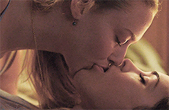 Megan Fox and Amanda Seyfried in a scene from Jennifer's Body, where Megan Fox's character is kissing Amanda Seyfried's character, portraying an intense and passionate moment between the two.