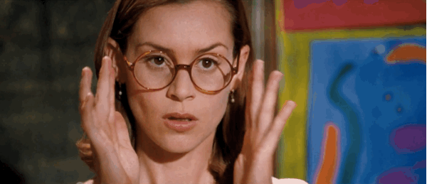 Miss Honey from Matilda lowering her glasses slightly, giving a soft, knowing look that hints at a moment of realization or awakening.