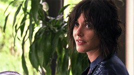 Katherine Moennig as Shane from 'The L Word,' looking flirtatious with a confident smile and intense gaze.