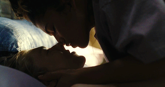 Zendaya as Rue from Euphoria and Jules sharing a kiss while on a bed