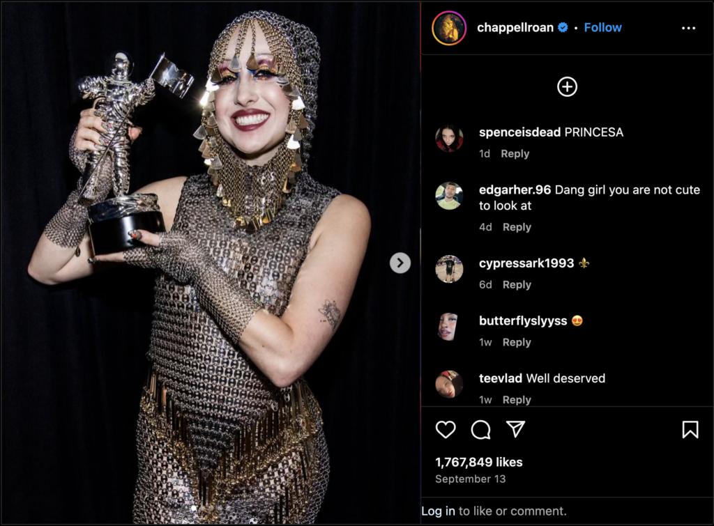 A screenshot of lesbian artist Chappell Roan’s Instagram showing her wearing head-to-toe chainmail after having won a VMA award.