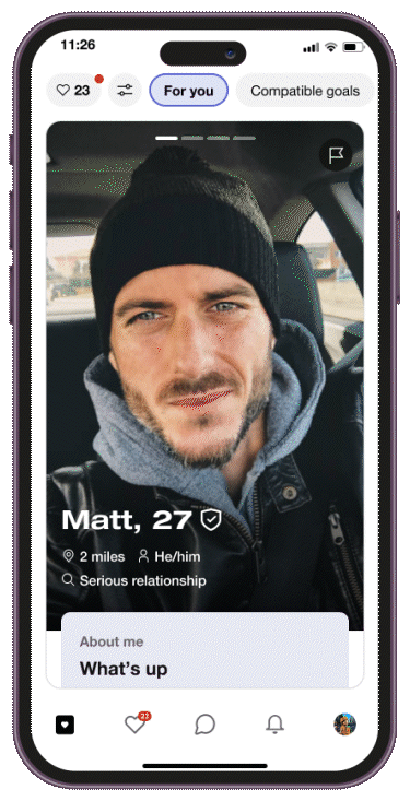 GIF showing a user on the HER app tapping the flag icon, triggering a message about removing cis men in Sapphic Mode, then confirming the profile has been removed.